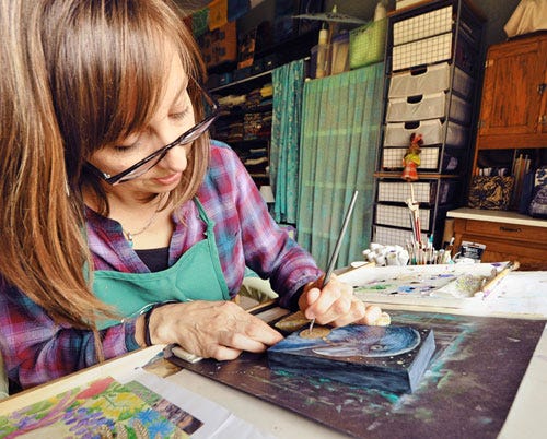 Ellen Paquette painting in her studio