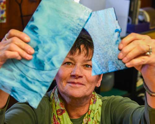 Kathleen Schnell with blue glass